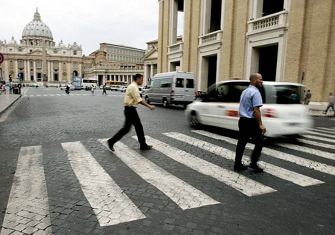 Gregorio Borgia/Associated Press Pedestrians cross the street as motorists drive past St. Peter&#039;s Square in Rome Tuesday, the day the Vatican issued a set of &quot;Ten Commandments&quot; for drivers.