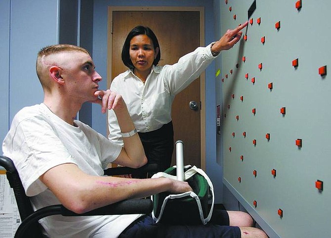 Chris O&#039;Meara/associated press Joshua Pitcher works with occupational therapist Imelda Llanos at the James A. Haley Veterans Hospital March 2 in Tampa, Fla. Pitcher was injured in Iraq by a grenade blast that left him with a traumatic brain injury and shrapnel in his arms and legs.