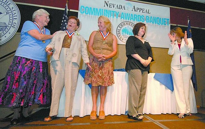 Kevin Clifford/Nevada Appeal Pat Holub, second from the left, reacts after winning the Artist of the Year award Tuesday during the Community Awards Banquet at the Carson Nugget.