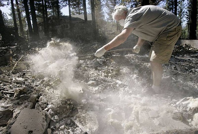 Jeff Chiu/Associated Press Keith Cooney searches for a firebox Friday as he digs through the remains of his home near South Lake Tahoe that was burned down on Sunday in the Angora wildfire.
