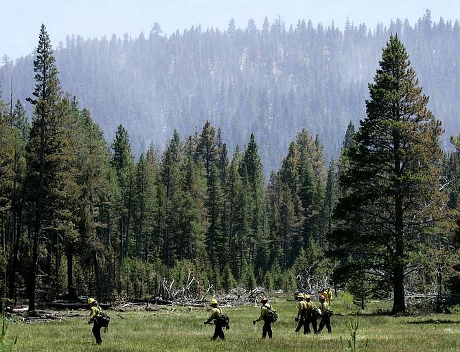 Ben Margot/Associated Press Firefighters walk near the leading edge of the Angora fire on Thursday in South Lake Tahoe.