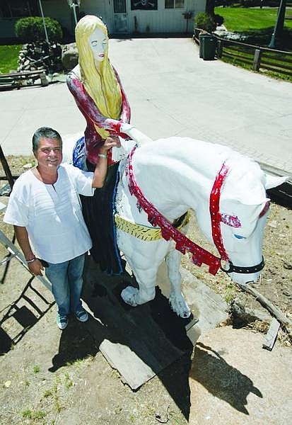 Photos by Chad Lundquist/Nevada Appeal Rudy Romo stands with Lady Godiva, his fiberglass statue that has become a recognizable fixture outside his home in North Carson City on Sunday. Romo celebrated his 61st birthday by painting Lady Godiva.