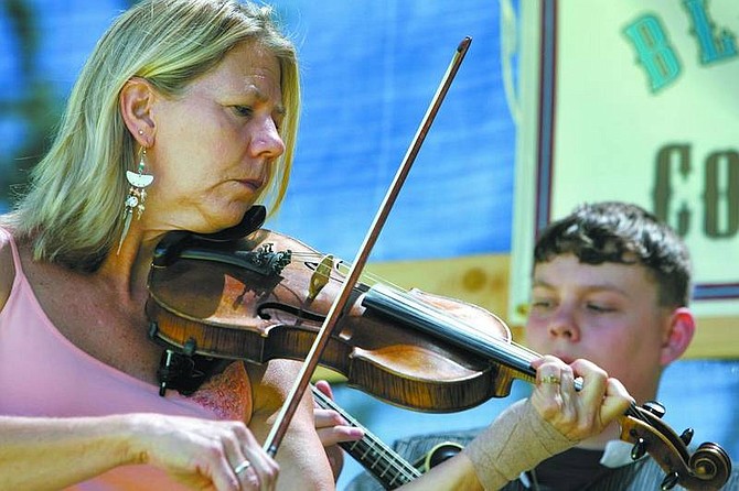 Nevada Appeal file photo Fiddle player Vicki Hass with The Back Forty Band performs at the 2006 Bluegrass on the Comstock Festival in Virginia City. The 2007 festival, which kicks off Friday, will feature a dozen bands from across the country.