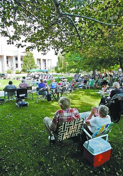 Chad Lundquist/Nevada Appeal Music lovers soak up the shade and sounds from the Mile High Jazz Band at the Legislative Plaza on Sunday afternoon.
