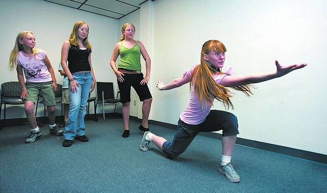 Chad Lundquist/Nevada Appeal Jayme Foremaster, 15, right, along with Bethany Mindrum, 14, Shelby Gutierrez, 13, and Isabella Favoro, 11, practice their improv skills during a rehearsal Monday for the Wild Horse Children&#039;s Theater at the Children&#039;s Museum of Northern Nevada.