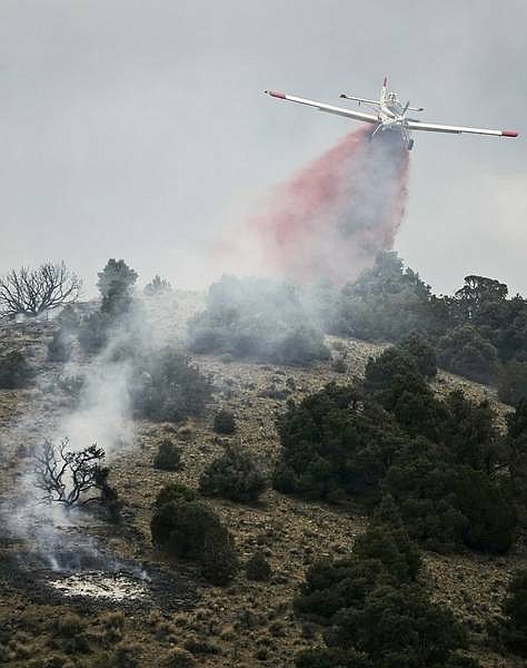 Chad Lundquist/Nevada Appeal An air tanker drops retardant on a fire that was sparked by lightning on the east side of Hot Springs Mountain, north of Johnson Lane on Tuesday. Four engines from Carson, Douglas County and the Bureau of Land Management responded along with a single-engine air tanker to contain the six-acre fire.