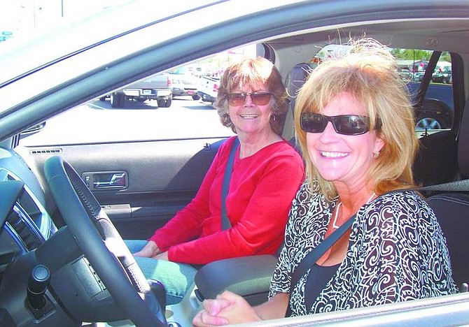 Chris Slabaugh/For the Appeal Kim Riggs,left, and her mother, Patricia Riggs, sit in the 2007 Ford Edge Kim Riggs received Friday at Capital Ford in the Bold Moves: Edge Across America Sweepstakes.