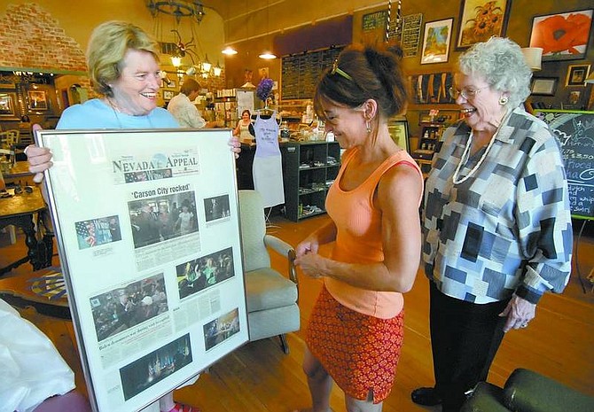 Kevin Clifford/Nevada Appeal Donna Kattchee, left, and Jean Amos, right, present June Joplin, owner of Comma Coffee, a poster on Friday made using clippings of photographs of the democratic candidates that stopped at Comma Coffee.