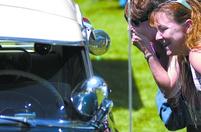 Shauna Thomas, right, and Layne Ortiz, left, from Las Vegas react while looking inside a 1951 Chevy Deluxe at the 2006 Silver Dollar Car     Classic.  File photo