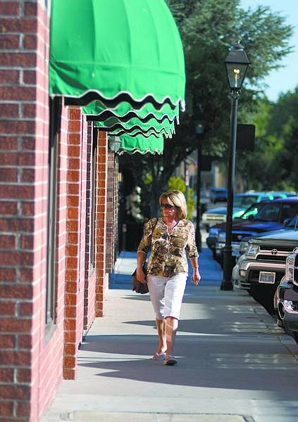Kevin Clifford/Nevada Appeal Judy Kassemos, 56, of Carson City, looks at window displays as she walks down North Curry Street on Tuesday. North Curry Street is part of the area being targeted by zoning changes to draw businesses downtown.