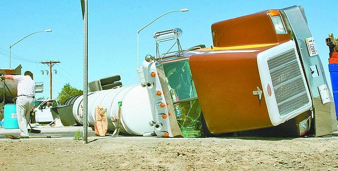 Rick Norton/Nevada Appeal News Service An 18-wheeler carrying chlorine flipped over in the Fernley roundabout Wednesday morning, causing 50 gallons of the substance to spill. Traffic was diverted around the incident for nine hours.