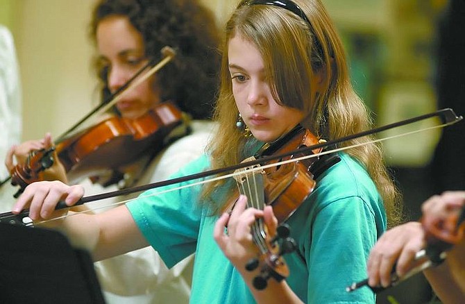 Kevin Clifford/Nevada Appeal Samantha Gates, 12, plays her violin during the &quot;Strings in the Summer&quot; Concert inside the Carson Mall on Thursday. The program is an extension of the Carson City Symphony&#039;s &quot;Strings in the Schools&quot; program.