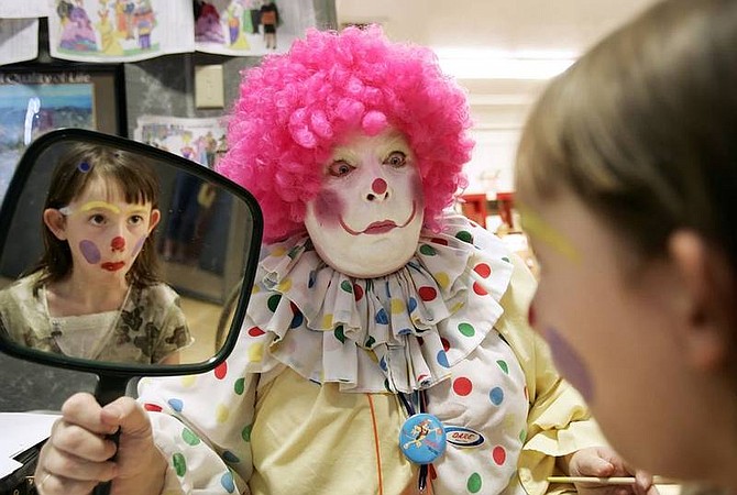 Chad Lundquist/Nevada Appeal Corey Clown, aka Donna Peacocke, shows Sarah Sorich, 6, her handy work after a face painting session at the Children&#039;s Museum of Northern Nevada on Sunday. Corey Clown, will be on hand at the museums annual &quot;Kids Karnival&quot;  scheduled for Saturday, Aug. 18 from 10 a.m. to 3 p.m.