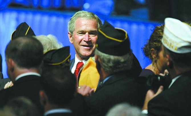 President Bush smiles as he greets members of the American Legion after his speech at their 89th national convention in Reno Tuesday.  Rich Pedroncelli/ Associated Press