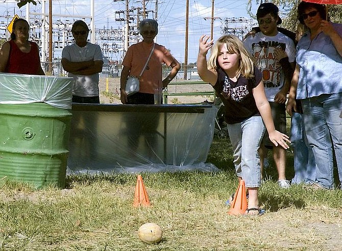 Christy Lattin &#149; LVN photo Kaylee King of Winnemucca lets a melon roll in the kids cantaloupe-bowling contest Saturday afternoon at the Cantaloupe Festival.
