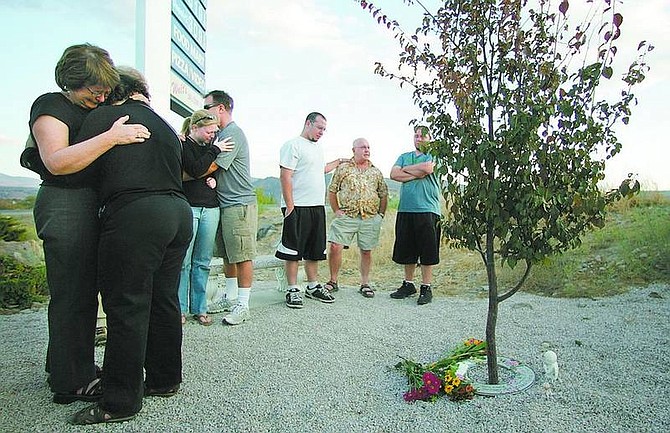 BRAD HORN/Nevada Appeal Phyllis Strickland, left, comforts Joyce Greene at a memorial garden dedicated to Greene&#039;s daughter Heather Deyerle near The General Store, where Heather worked. Pictured at right is Mike Greene, Heather&#039;s father; and brothers Frank, in white, and Mike Jr. Heather&#039;s estranged husband, Christopher Deyerle, was convicted of first-degree murder Monday.