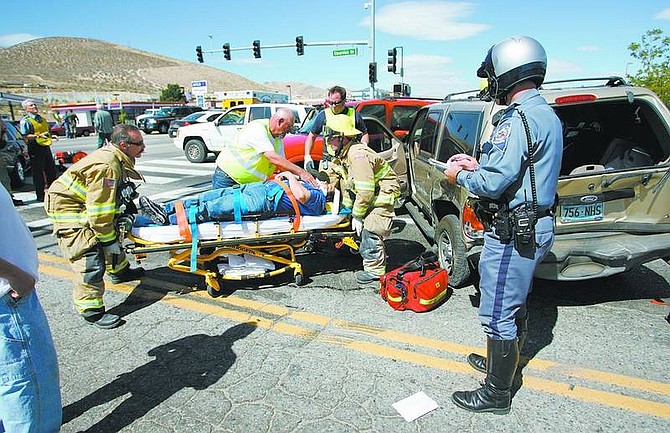 Cathleen Allison/Nevada Appeal Firefighters transported several people to area hospitals following a six-car accident at South Carson Street and Clearview Drive on Tuesday afternoon. The accident briefly closed South Carson Street and caused two people to be taken by Care Flight Helicopter because of their injuries.