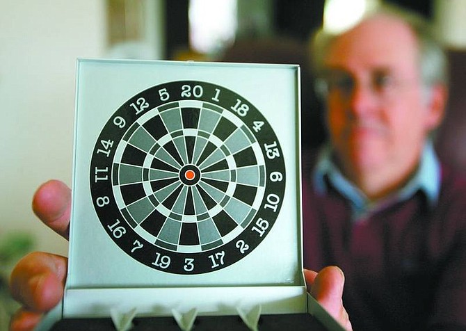 BRAD HORN/Nevada Appeal Peter Fishburn helps businesses market their products or services better with the help of promotional items like this miniature dartboard.