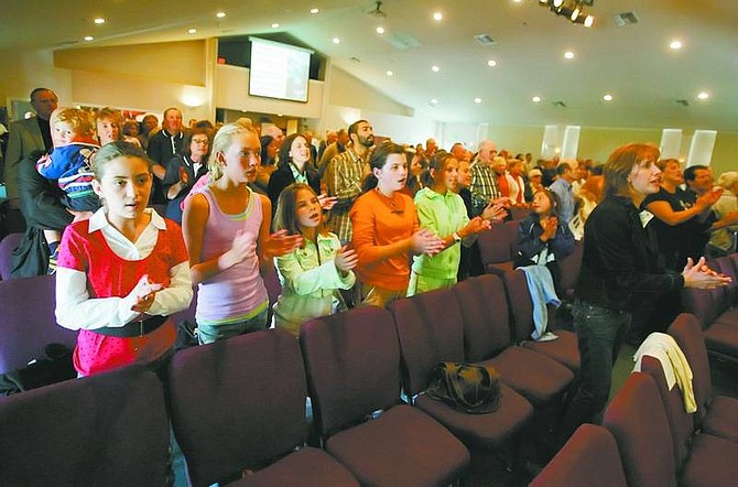 BRAD HORN/Nevada Appeal Katie Antti, 11, from left, Shaelin Morefield, 11, and Hannah Harville, 10, sing &#039;Blessed Be Your Name&#039; at the Hilltop Community Church on Sunday.