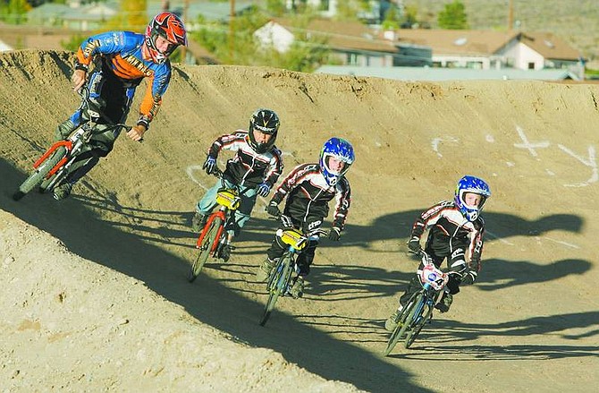 BRAD HORN/Nevada Appeal Eli Piper, from left, Brandon Copeland, 6, Mallory Otto, 8, and Molly Otto, 8, ride at the Carson track on Wednesday.