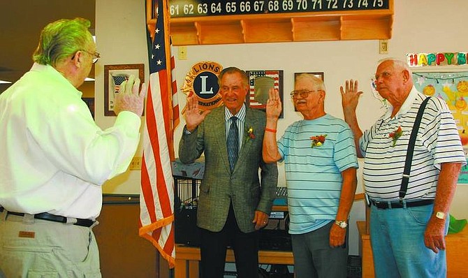 Rhonda Costa-Landers/Nevada Appeal Lyon County Commissioner Bob Milz, left, swears in members to the Dayton Senior Center Advisory Council Tuesday at the center. Being sworn in, from left, are re-elected members Edward Johnson and Tom Hass, and newly elected member Joseph Emanuelson.