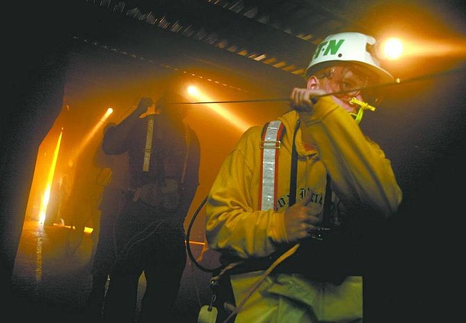 Andrew Rush/Associated Press Richard Nichols, of Waynesburg, Pa., leads a group of his classmates through a simulated mine scenario using escape respirators at the Mining Technology and Training Center in Ruff Creek, Pa., Sept. 12.