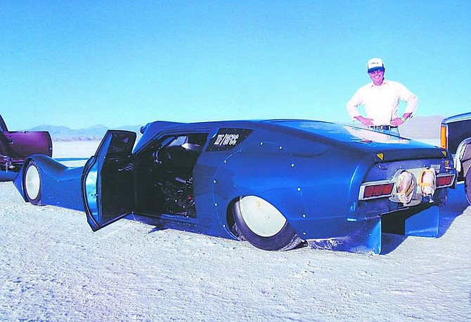 Photo submitted by Dan Webster Dan Webster, of Carson City, stands next to the car that won the land speed record on Sept. 13 in the blown fuel competition coupe division on the Bonneville Salt Flats in Utah.
