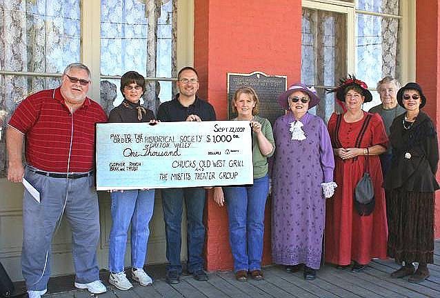 Photo submitted Members of the Misfits Theatre Group and Chuck&#039;s Old West Grill present a check for $1,000 to the Dayton Historical Society to help restore the Carson &amp; Colorado Railroad Depot in Old Town.