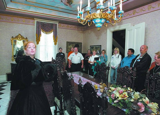 Photos by Cathleen Allison/Nevada Appeal Mary Bennett, of the Br&#252;ka Theatre in Reno, portrays Elizabeth Bliss on Oct. 11 during a tour of the Bliss Mansion with Chamber of Commerce Leadership students. Bennett was preparing for the Kit Carson Trail Ghost Walk, which takes place Saturday.