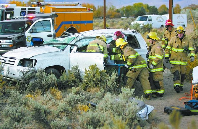 Cathleen Allison/Nevada Appeal Carson City firefighters remove a Dayton woman from her car after an accident at Arrowhead Drive, near Technology Way, on Thursday morning.