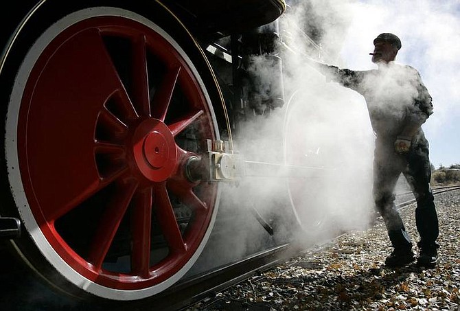 Chad Lundquist/Nevada Appeal Lee Hobold, an engineer with the Nevada State Railroad Museum stands next to locomotive No. 22 as it belches steam on Sunday morning. It&#039;s the first time in a decade and a half that the famous locomotive also known as the Inyo has taken to the tracks.