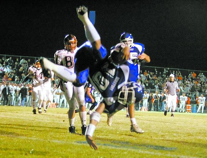 BRAD HORN/Nevada Appeal Carson quarterback Mitch Hammond does a back flip into the endzone during the first quarter of their game against Douglas on Thursday.