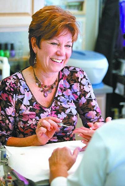 Cathleen Allison/Nevada Appeal Kim Sayre gives a manicure at Handjive in Mound House on Wednesday.