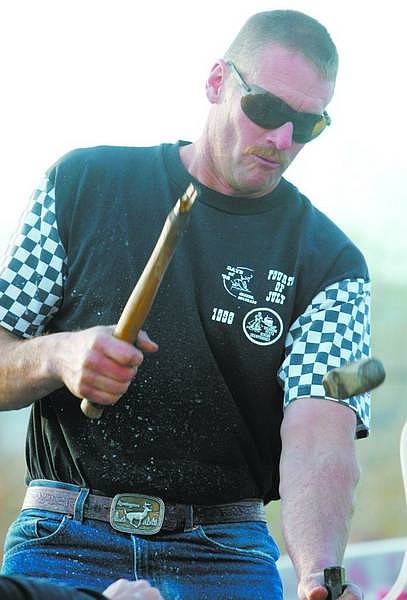 BRAD HORN/Nevada Appeal Tom Donovan breaks the hammer head while competing Saturday in the World Championship Rock Drilling contest in the Carson Nugget parking lot.