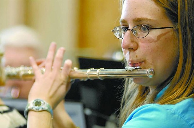 Kevin Clifford/Nevada Appeal Capital City Community Band member Tiffany Moore, 16, of Carson City plays her flute during the Community band concert at the Nevada State Railroad Museum on Sunday.