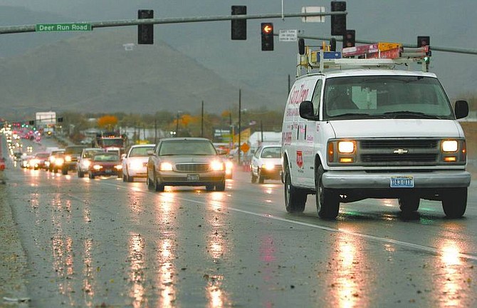 Trevor Clark/Nevada Appeal Cars line up in traffic heading eastbound on Highway 50 during the storms on Monday. Power outages caused many traffic light failures after lightning knocked out a substation for more than an hour.