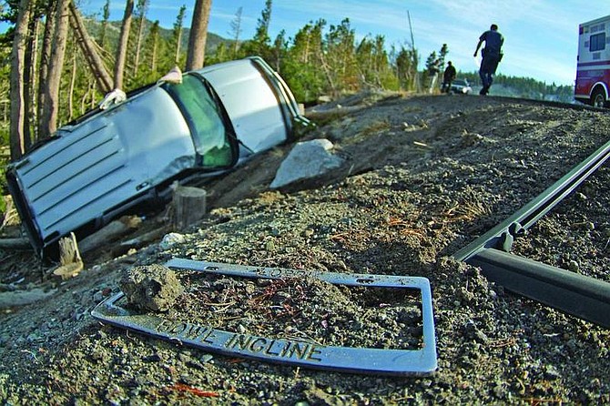 Carrie Richards/Associated Press Lorri Waldman&#039;s &#039;Bowl Incline&#039; license plate cover lays on the ground near her car that flipped and slid off Hwy. 431 Friday afternoon a half mile east of the summit. Waldman had no major injuries visible but was taken to a hospital in Reno as a precaution.