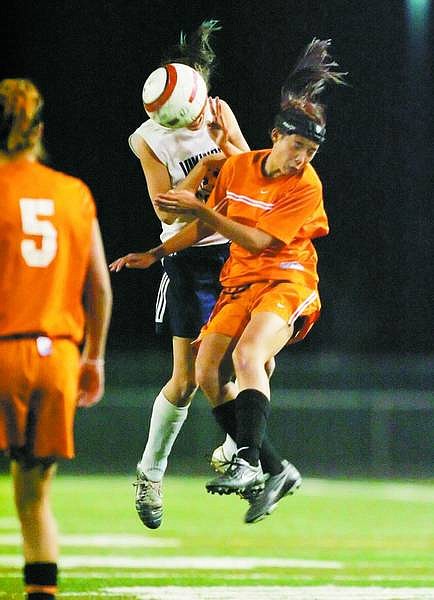 BRAD HORN/Nevada Appeal Douglas High&#039;s CJ Baumgartner, right, battles South Lake Tahoe&#039;s Sarah Burks during the second half of their NIAA semi-final playoff game at Damonte Ranch High School Wednesday. South Lake Tahoe beat Douglas 1-0.
