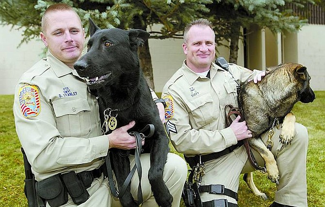 Shannon Litz/Nevada Appeal News Service David Stanley with Hondo and Joe Duffy with Bella at the Douglas County Sheriff&#039;s Office on Wednesday.