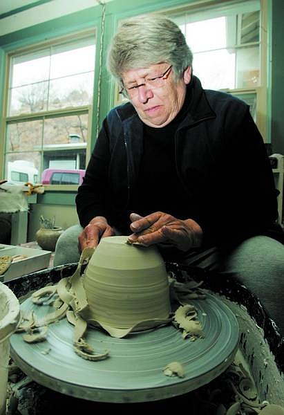BRAD HORN/Nevada Appeal Mimi Patrick cuts a clay piece at her studio Argenta Earth and Fire in Gold Hill on Wednesday. Patrick began making clay art 36 years ago when she took a class at a community college.