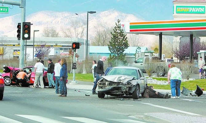 BRAD HORN/Nevada Appeal Witnesses and bystanders assist motorists involved in a three-car accident at the corner of Fairview Drive and Highway 50 East on Saturday morning. A portion of Fairview was closed.