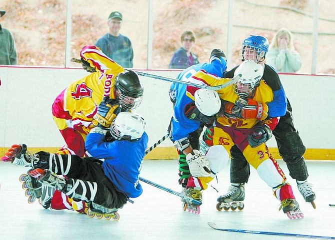 BRAD HORN/Nevada Appeal Nevada and USC fight during their roller hockey match at the Pony Express Pavilion in Mills Park on Saturday.