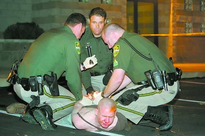 BRAD HORN/Nevada Appeal Carson City Sheriff&#039;s deputies detain Raymond Nattrass, 17, after he and two others allegedly jumped a Department of Public Safety peace officer and wrestled away his gun. This photograph was withheld from Thursday&#039;s paper after police reported that Nattrass was a juvenile. On Friday, Nattrass was certified as an adult, and will be tried as an adult on various felony charges, including principal to attempted murder.