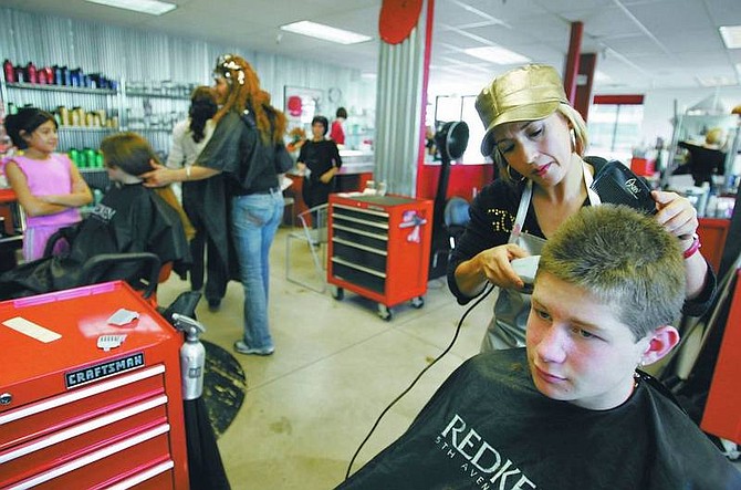 BRAD HORN/Nevada Appeal Advanced stylist Emilia Camacho cuts 14-year-old Cole Chandler&#039;s hair at Platinum Salon &amp; Spa in Carson City on Saturday.