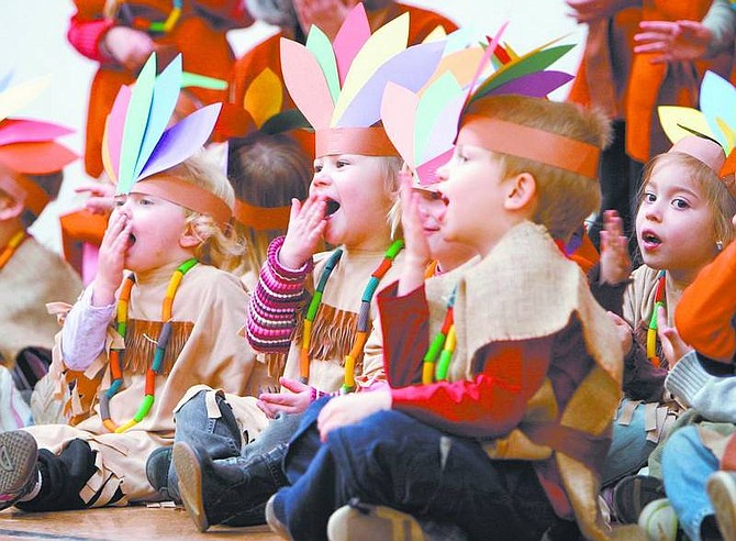 Amy Lisenbe/Nevada Appeal Kinderland Nursery School students Shelby Wickstead, left, Jocelyn Foster, center, and Taylor Matthews, right, gesture as they sing an Indian song Tuesday afternoon during the school&#039;s Thanksgiving performance and dinner at the Carson City Community Center.