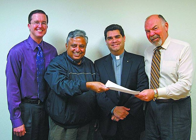 Photo provided Members of the Gandhi Monument Council, from left, Rev. Alan Dorway, Hindu leader Rajan Zed and Rev. Gene Savoy Jr., bishop of the International Community of Christ, present the state Director of Cultural Affairs Michael Fischer, a memorandum requesting state help to establish a monument honoring the values of Mahatma Gandhi.