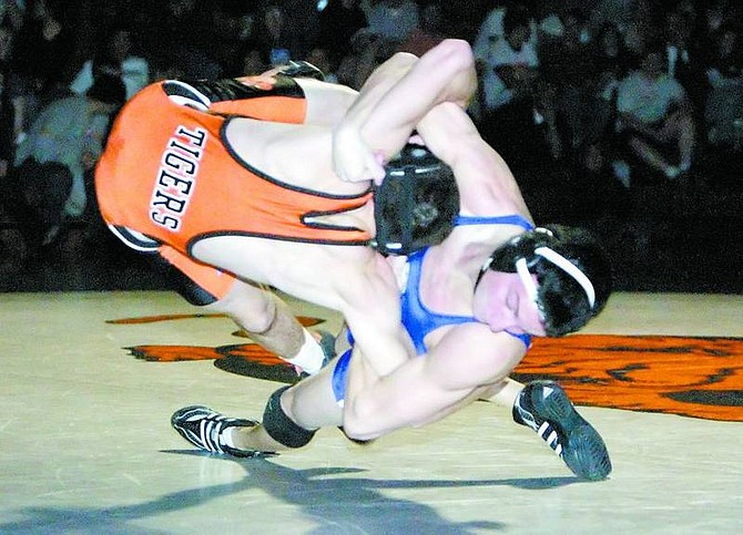 BRAD HORN/Nevada Appeal Carson&#039;s Todd Banko takes down his opponent in a match against the Douglas Tigers in Minden on Thursday. Banko won his match with a pin.