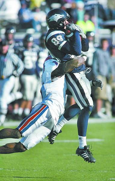 Nevada&#039;s Mike McCoy makes an 11-yard reception against Louisiana Tech defender Tony Moss during Saturday&#039;s football game, Dec. 1, 2007 in Reno, Nev. (AP Photo/Nevada Appeal, Cathleen Allison)