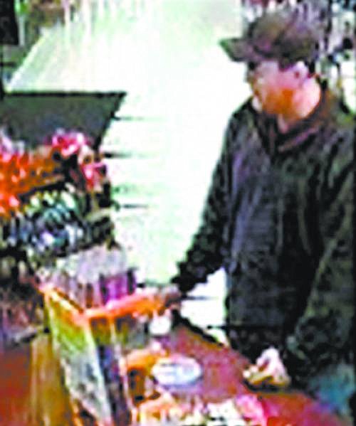 Police want to know who  the man is in this image taken from surveillance video. He&#039;s seen here using a stolen credit card to make a $16 purchase at Quik Stop on Roop Street and Hot Springs Road on Nov. 18.   photo provided