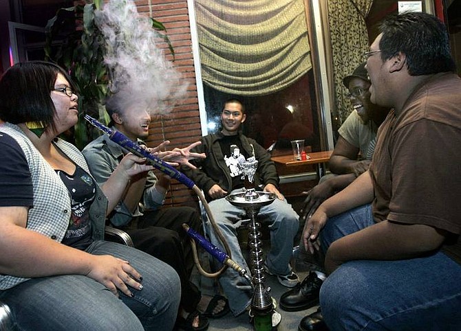 Kayla Crow, left, John Guava, Ryan Tong, Brian Bello and Tim Cheung at Long Beach&#039;s Mirage Coffeehouse and Hookah Lounge. Hookah bars are popular among 18- to 24-year-olds.